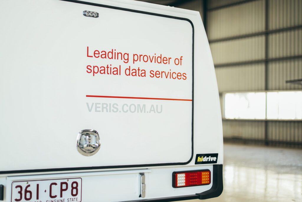 Veris fleet service body with signage, 'Leading provider of spatial data services