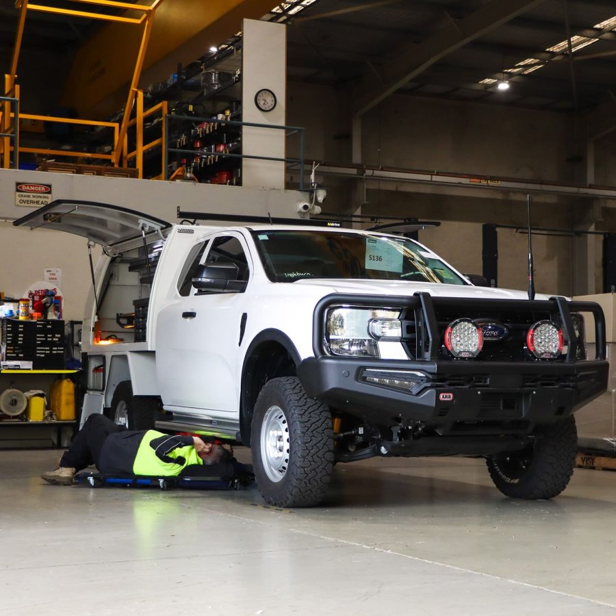 Technician under Ford service ute at Hidrive Sydney Factory
